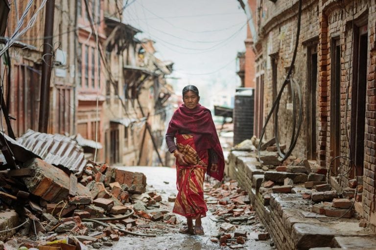 Woman waling through rubble, Kathmandu